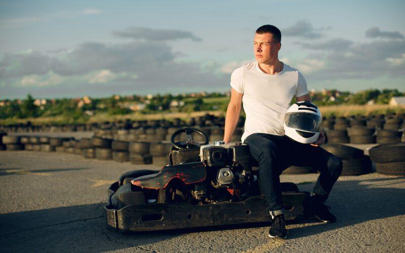 handsome man in a karting with a car